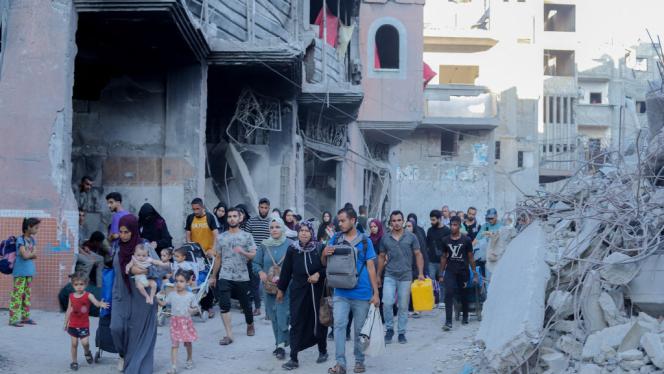 Displaced Palestinians flee their homes with their belongings in the Bureij refugee camp in Deir al-Balah, in the Gaza Strip on Sunday, July 28, 2024,